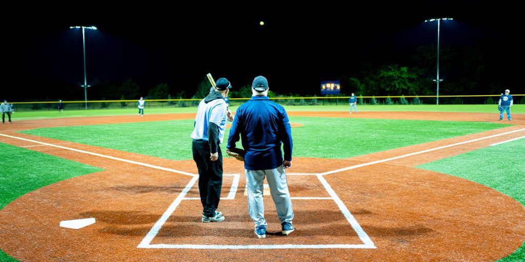 Softball game being played at night under Events Park's new Musco lighting system