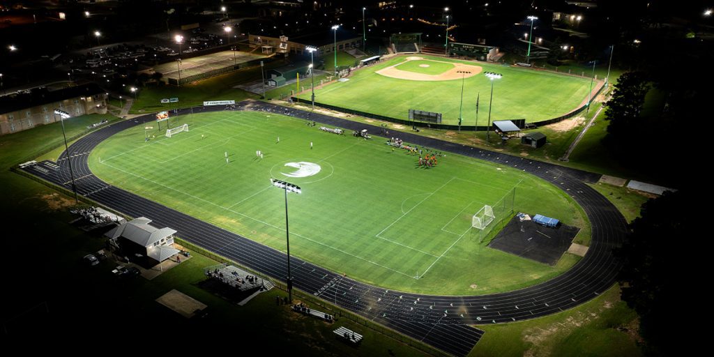 Night photo of Meridian Community College outdoor sports facilities after soccer and baseball field lighting upgrade with Musco