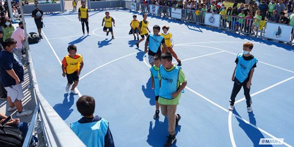 Students at the Community School of Excellence play soccer on the brand new mini-pitch