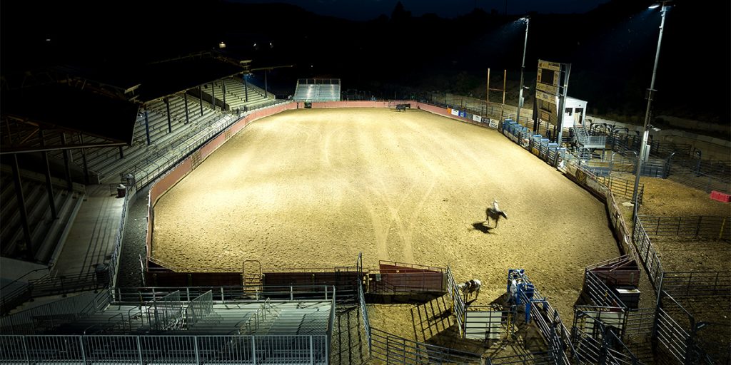 Horses working in the main arena at the Eagle County Fair and Rodeo after upgrading arena lights to Musco’s TLC for LED® system.