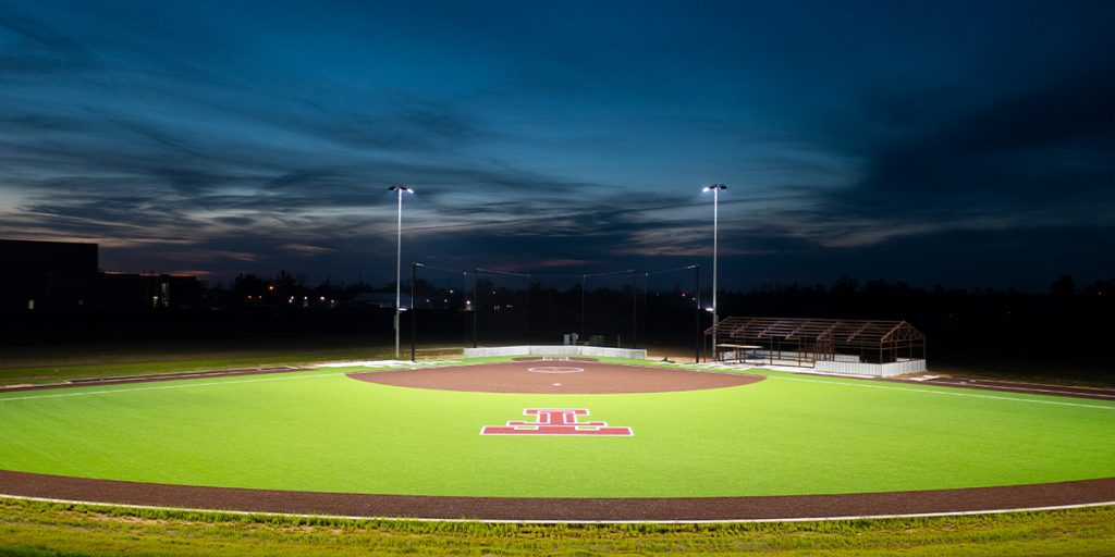 Tuttle High School softball field viewed from the outfield with new Musco TLC for LED lighting fixtures