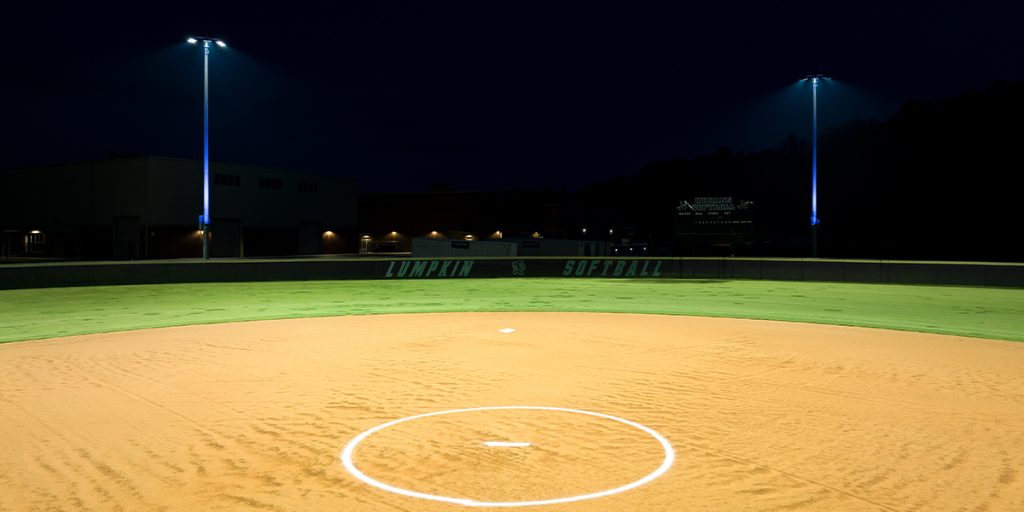 Lumpkin County High School baseball field after retrofitting to Musco LED sports lighting. Poles are lit with blue accent lights.