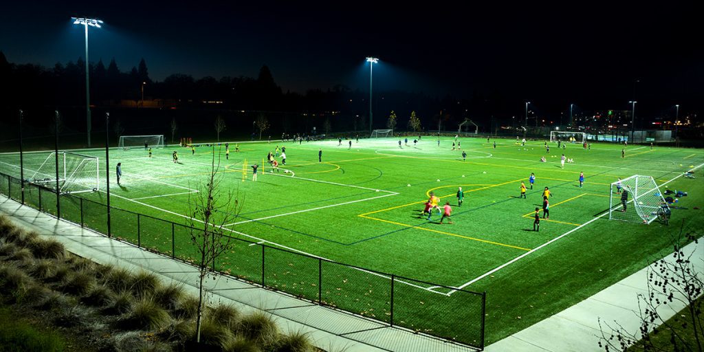 Athletes practice at night at Econome Family Park after the City of Folsom updates soccer field lighting to Musco LED sports lighting.