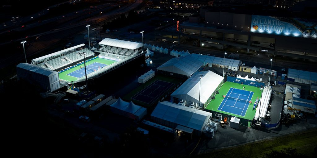 Tennis courts at the Truist Atlanta Open temporary venue lit with LED lighting from Musco Mobile.
