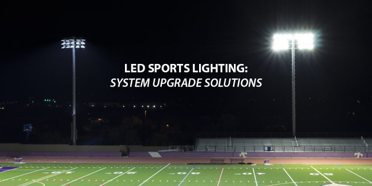 Two light poles with Musco LED sports lighting on the left and competitors lights on the right