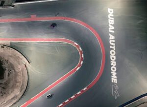 Gray racetrack with Dubai Autodrome written in white letters.