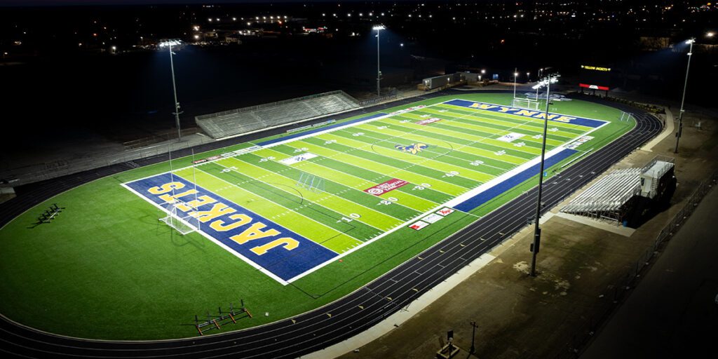 Overhead shot of the Wynne High School Yellow Jackets football stadium with new LED lighting poles and fixtures in the background.