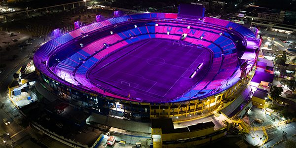 Field and seats at Estadio UANL Tigres Stadium lit in violet.