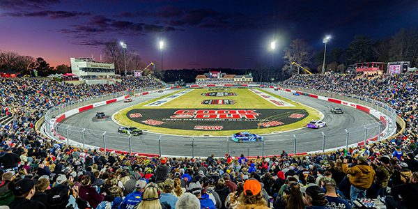 NASCAR fans watch night racing at Bowman Stadium with Musco mobile LED lighting in the background.