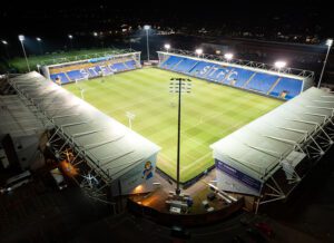 Temporary LED lighting system with Croud Meadow soccer field and blue stands in the background.
