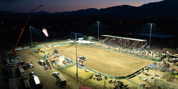Rodeo arena lights turn on at Douglas County Fairgrounds as the sunsets.