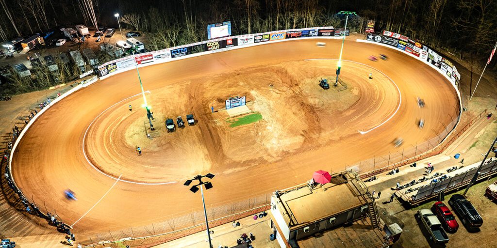 Grassroots drivers race under new LED lights at Millbridge Speedways dirt track, while RGBW fixtures light the the poles green.