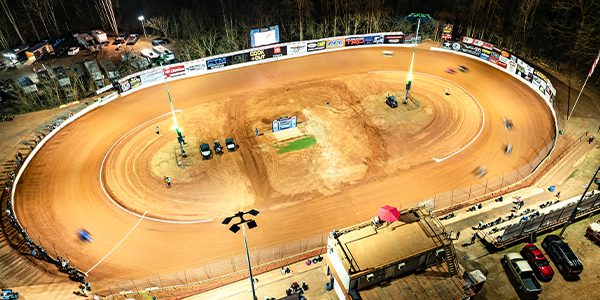 Grassroots drivers race under new LED lights at Millbridge Speedways dirt track, while RGBW fixtures light the the poles green.