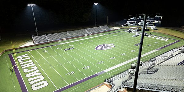 Oachita Baptists University's football field at Cliff Harris Stadium viewed from above with Musco LED lighting system in the foreground.